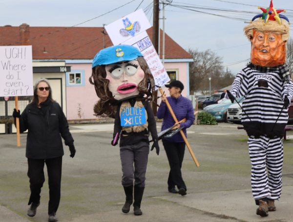giant paper mache president and ICE agent.